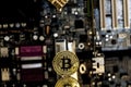 Golden bitcoin in front of a motherboard Royalty Free Stock Photo