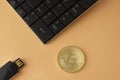 Golden bitcoin, keyboard and flash drive top view