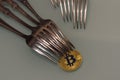 Golden bitcoin and silver forks around Royalty Free Stock Photo