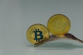 Golden bitcoin and silver forks around Royalty Free Stock Photo