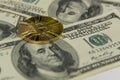 Golden bitcoin lie on one hundred dollar bills Royalty Free Stock Photo