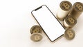 golden Bitcoin and mobile phone mockup next to stacks of Bitcoins isolated on white background Royalty Free Stock Photo