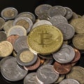 Golden bitcoin over a pile of coins Royalty Free Stock Photo