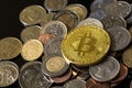 Golden bitcoin over a pile of coins. Royalty Free Stock Photo