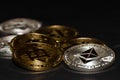 golden bitcoin and silver ether coins from cryptocurrency on black macro