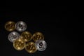 golden bitcoin and silver ether coins from cryptocurrency view from above on black