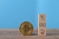 Golden bitcoin and wooden block with buy, sell and trade symbols