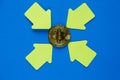 Golden bitcoin with yellow paper arrows on blue background. Internet security, risk, investment, business concept. Royalty Free Stock Photo