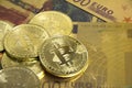 Golden bitcoins on euro banknotes, closee up Royalty Free Stock Photo