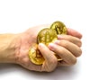 Golden bitcoins in hand. Digital symbol of a new virtual currency on white background. Royalty Free Stock Photo