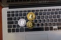 Golden bitcoins lies on silver notebook keyboard