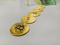 Golden bitcoins lined on white background with paper money bill in the back showing a new way of digital marketing dominated by