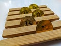 Golden bitcoins lined on wooden platform as a concept of investing and collecting cryptocurrencies based on blockchain technology