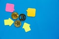 Golden bitcoins with yellow paper arrows on blue background. Internet e- commerce, security, risk, investment, business concept Royalty Free Stock Photo