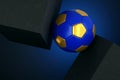 Golden and Blue Football Soccer Ball between 2 Solid Concrete Blocks - 3D Illustration