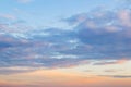 Golden blue sunset sky with light clouds. Vanilla sky. Tranquil skyscape just before the sundown. Pastel scenic cloudscape for