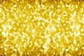 Golden blurred shining bokeh background, defocused yellow sparkles backdrop, gold color round bubbles blur effect, bright lights Royalty Free Stock Photo