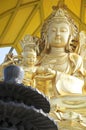 Golden Bodhisattva and black incense burner Royalty Free Stock Photo