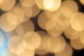 Golden bokeh on a black background, abstract dark backdrop with defocused warm lights and blue highlight Royalty Free Stock Photo