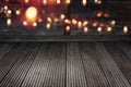 Golden bokeh on dark shabby wood