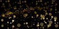 Golden bokeh lights sparkles of glitter dust particles dark abstract overlay background