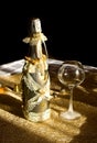 Golden bottle champaign and empty goblet Royalty Free Stock Photo