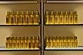 Golden bottles in a row on a shelf.