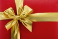 Golden bow on a red background (holiday background)