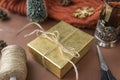 Golden box with Christmas gift scissors, rope, cones, tea mug Royalty Free Stock Photo