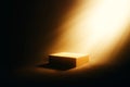 Golden box illuminated by a dramatic beam of light in darkness Royalty Free Stock Photo