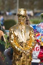 Golden boy covered from head to toe in gold with reflective top hat