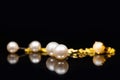 Golden bracelet and earstuds with white pearls in it Royalty Free Stock Photo