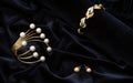 Golden bracelets and earrings pair on blue velvet fabric background Royalty Free Stock Photo