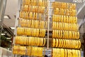 Golden bracelets in the jewelry showcase. Golden accessories in a shop window of a jewellery store. Selective focus. Blurred Royalty Free Stock Photo