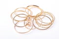 Golden bracelets and jewelry, white background.