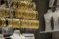 Golden bracelets in a shelf on a showcase of goldsmith, close up Royalty Free Stock Photo