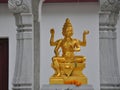 Golden Brahma sculpture in Hindi Shrine