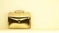 Golden briefcase on yellow background