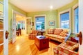 Golden bright green luxury living room with red sofas.