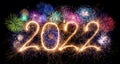 Golden bright modern sparkler number 2022 with colorful fireworks isolated black. happy new year eve celebration background Royalty Free Stock Photo
