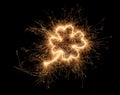 Golden bright sparkler four leaf clover shape happiness shaped symbol isolated dark black background. silvester new year birthday