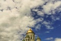 Domes of the temple against the background of a bright blue sky with clouds Royalty Free Stock Photo