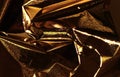 Golden and bronze foil texture with a glossy, metallic finish, creating a sleek, modern backdrop.