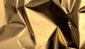 Golden and bronze foil texture with a glossy, metallic finish, creating a sleek, modern backdrop.