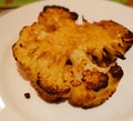 Golden brown baked cauliflower steak on baking tray ready to be eaten