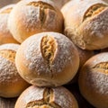 Golden brown bread rolls with a dusting of flour on top, displaying a smooth, round Royalty Free Stock Photo