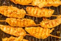 Golden brown chicken kababs grilling on pan