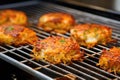 golden brown crab cakes cooling on a wire rack