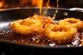 golden brown crispy onion rings frying Royalty Free Stock Photo