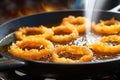 golden brown crispy onion rings frying Royalty Free Stock Photo